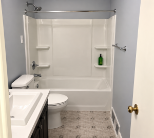 Sterling Ensemble remodelers unit with bathtub and three-piece shower wall surround by Madison's Homes